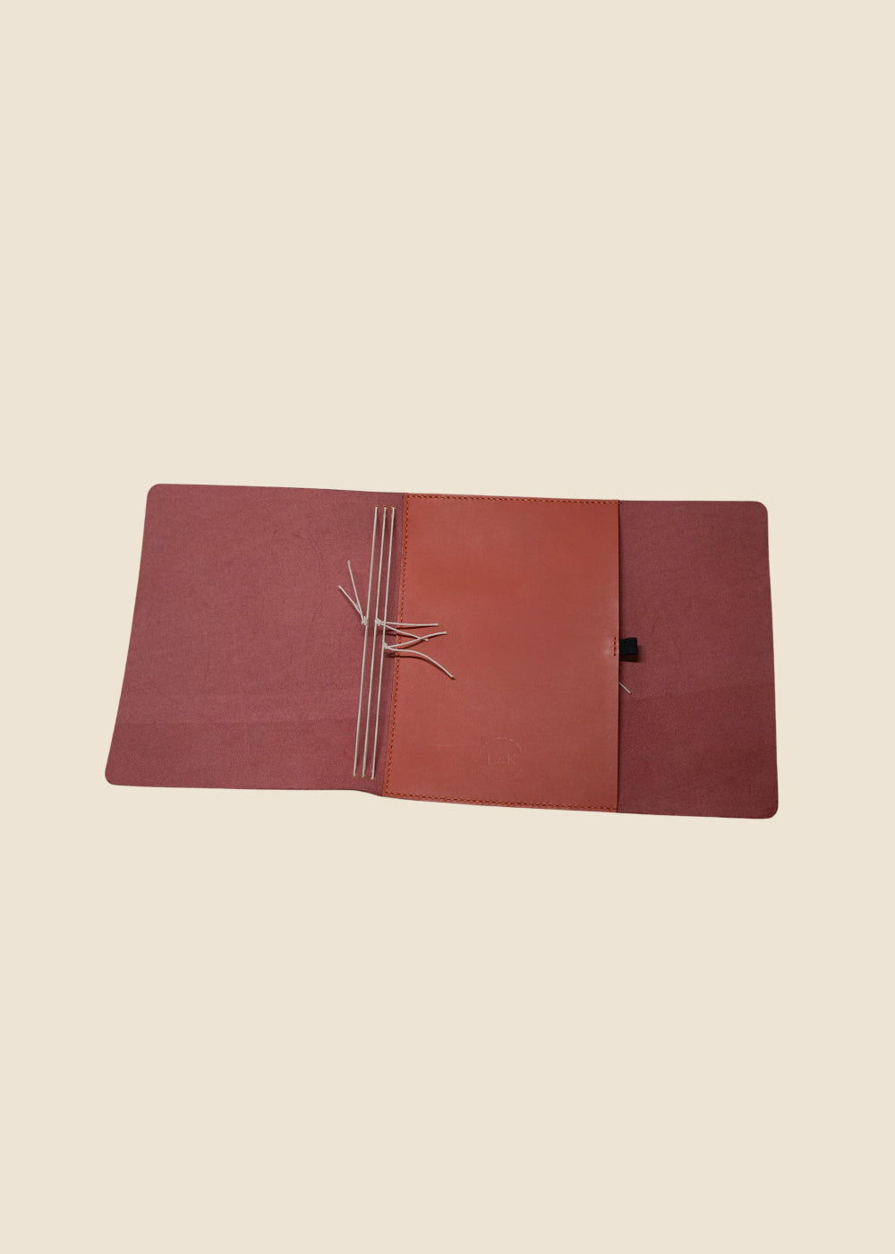 Open Heatherfield A6 leather journal showing hand-stitched interior pockets