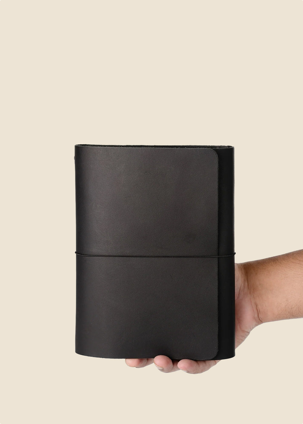 Heatherfield A6 leather journal held in hand in black leather