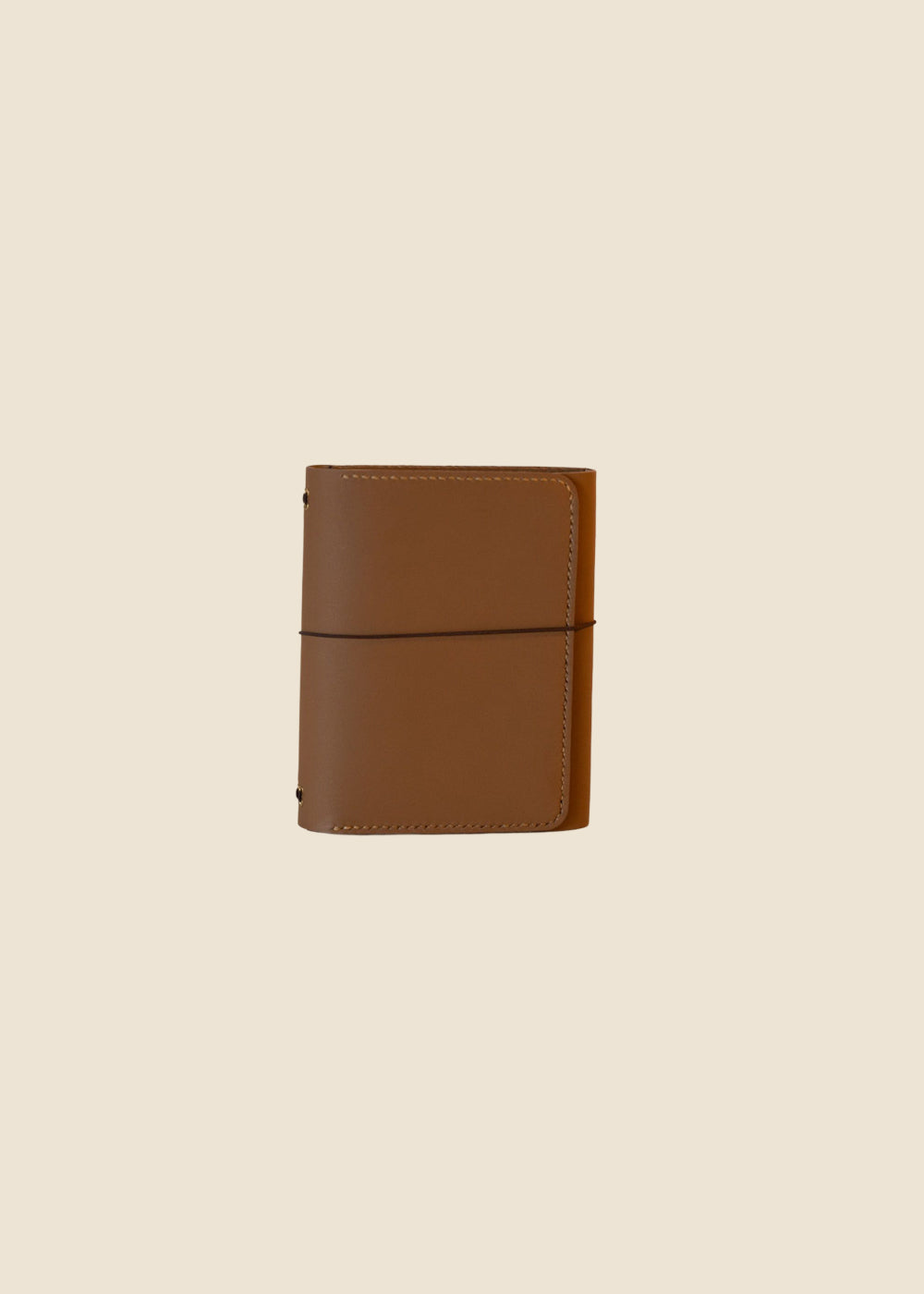 Heatherfield A6 leather journal held in hand in caramel leather