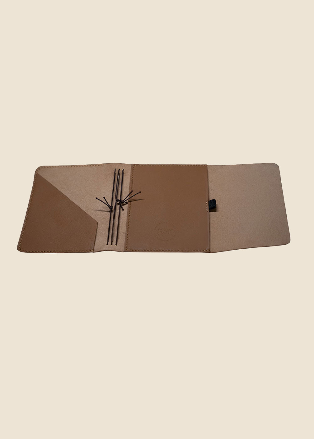 Open Heatherfield A6 leather journal showing hand-stitched interior pockets